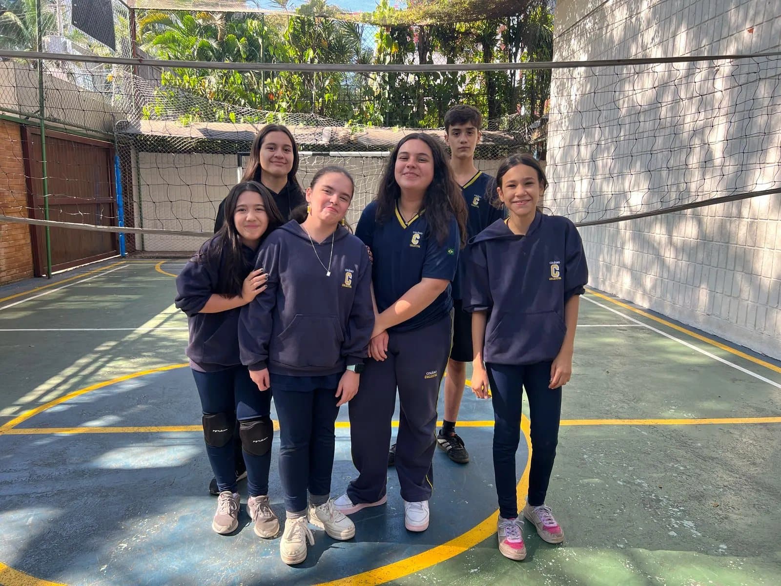 Alunas do Ensino Médio na quadra poliesportiva, ao ar livre